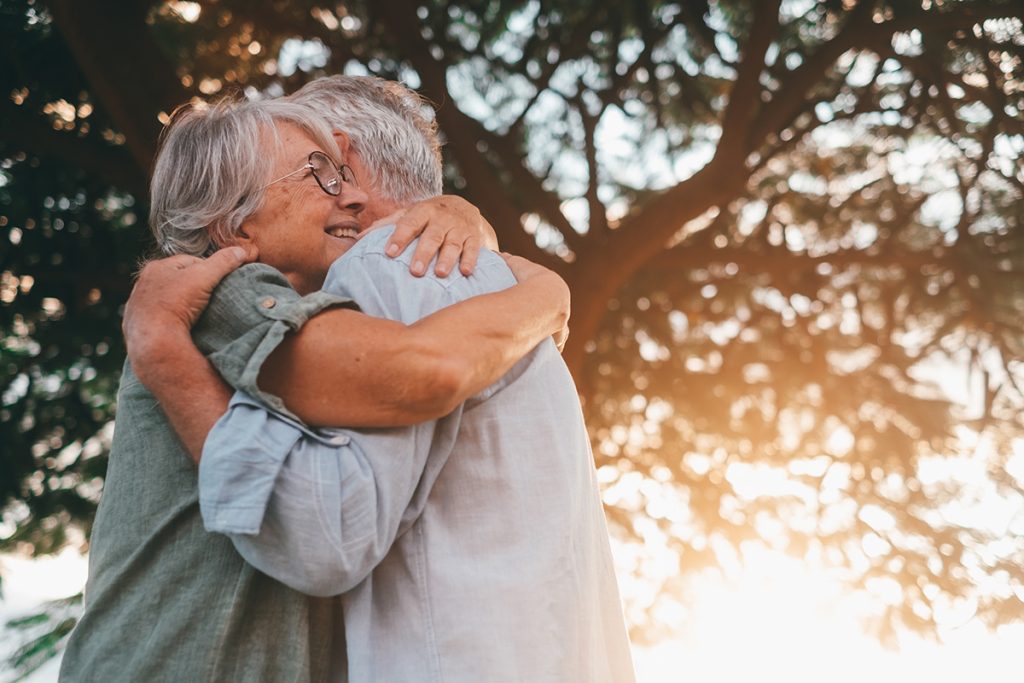 Older happy couple hugging