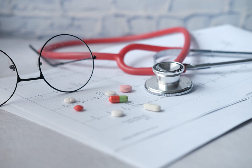 prescription medical pills, stethoscope on a cardio diagram